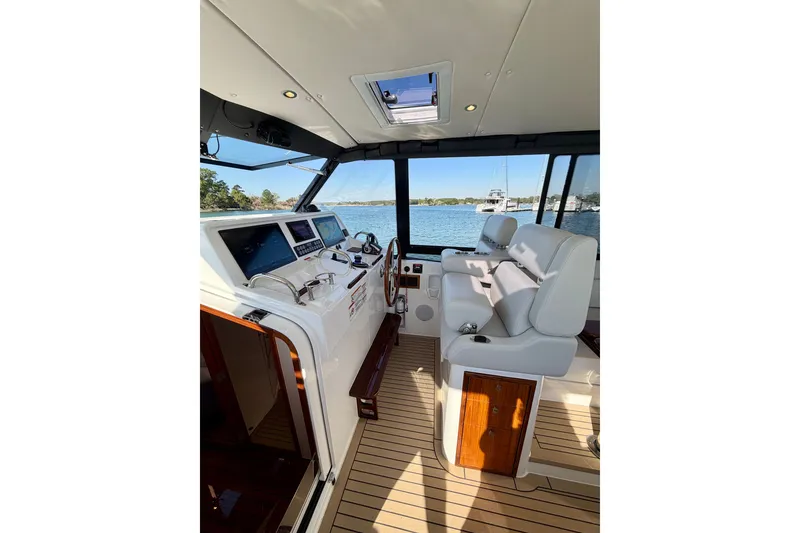 Slide: The Image of Interior of 2025 MJM 4 boat, featuring modern helm and luxurious seating. - 23