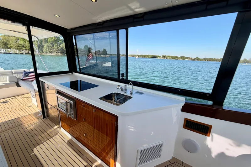 Slide: The Image of Luxury interior of 2025 MJM 4 yacht with modern kitchenette and scenic water view. - 22