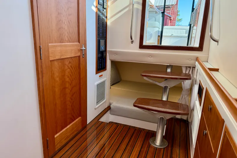 Slide: The Image of Interior of 2025 MJM 4 boat with wooden flooring and compact seating area. - 39