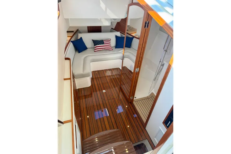 Slide: The Image of Luxurious 2025 MJM 4 yacht interior with elegant wood flooring and cozy seating area. - 34