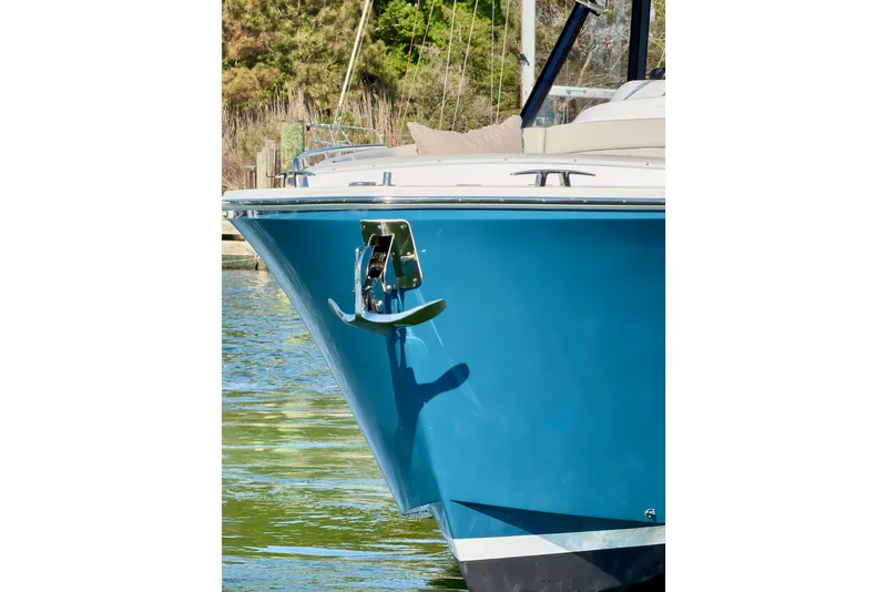 Slide: The Image of Bow of 2025 MJM 4 boat with blue hull and anchor in water. - 13