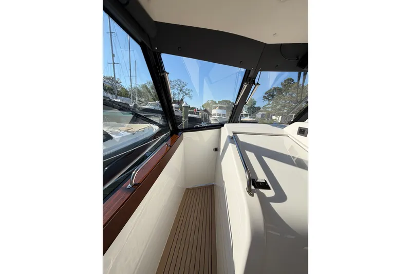 Slide: The Image of Interior view of 2025 MJM 4 boat, featuring sleek design and wooden flooring. - 44