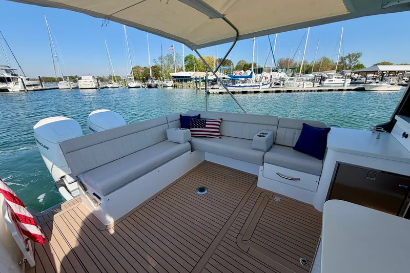 Slide: The Image of Luxury MJM 4 boat interior with seating, docked at marina, 2025 model. - 19
