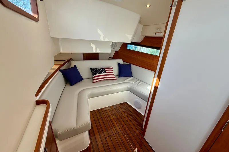 Slide: The Image of Luxurious 2025 MJM 4 yacht interior with elegant seating, wooden accents, and decorative pillows. - 35