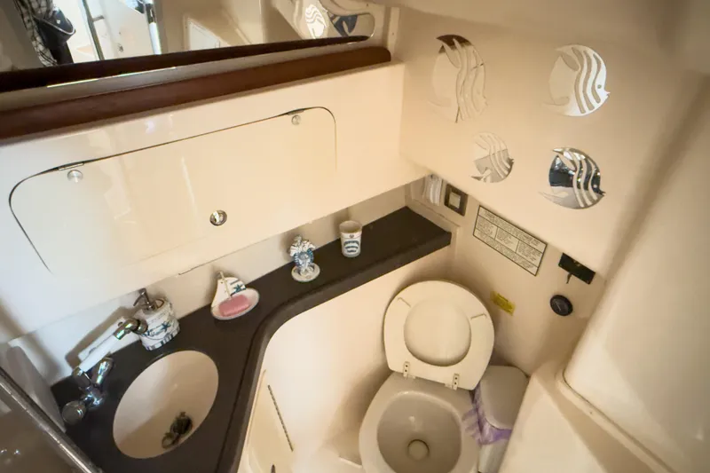 Slide: The Image of 2006 Grady-White Express 330 boat bathroom with sink, toilet, and decorative elements. - 18