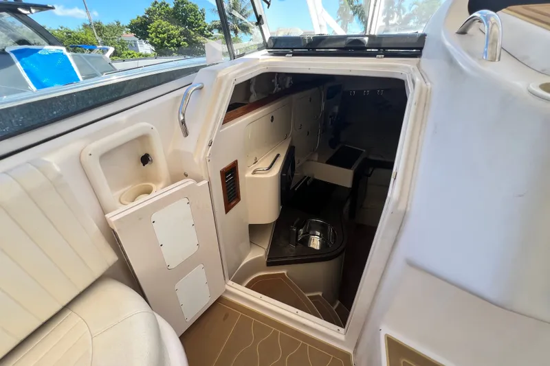 Slide: The Image of Interior view of 2006 Grady-White Express 330 boat cabin with seating and storage. - 25