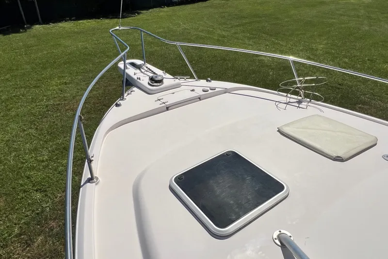 Slide: The Image of 2006 Grady-White Express 330 boat deck with railing and hatch, on grassy area. - 41