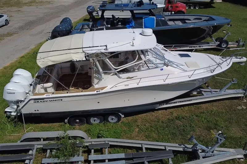 Slide: The Image of 2006 Grady-White Express 330 boat on trailer, parked on grass. - 4