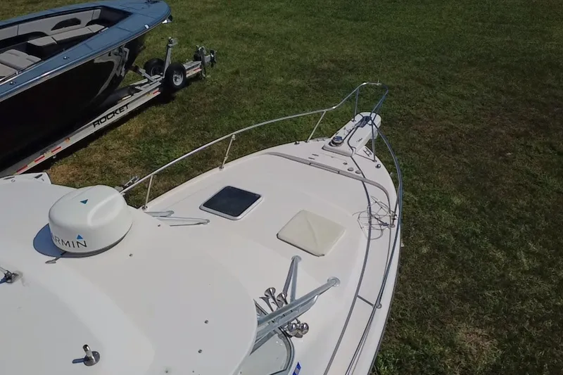 Slide: The Image of 2006 Grady-White Express 330 boat on grass, with Garmin equipment visible. - 12