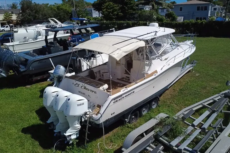 Slide: The Image of 2006 Grady-White Express 330 boat on grass with twin Yamaha engines. - 1