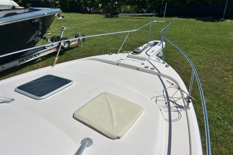Slide: The Image of 2006 Grady-White Express 330 boat on grass, showcasing bow and deck features. - 47
