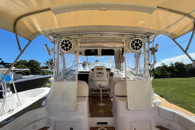 Slide: The Image of 2006 Grady-White Express 330 boat interior with seating and canopy, showcasing marine speakers. - 18