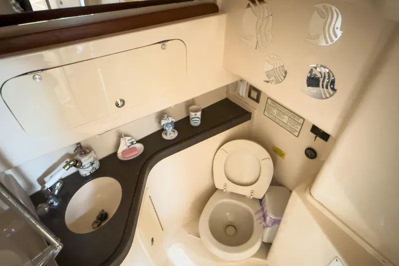Slide: The Image of 2006 Grady-White Express 330 boat bathroom with sink, toilet, and decorative accents. - 19