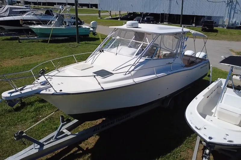 Slide: The Image of 2006 Grady-White Express 330 boat on trailer, parked outdoors in a marina setting. - 6