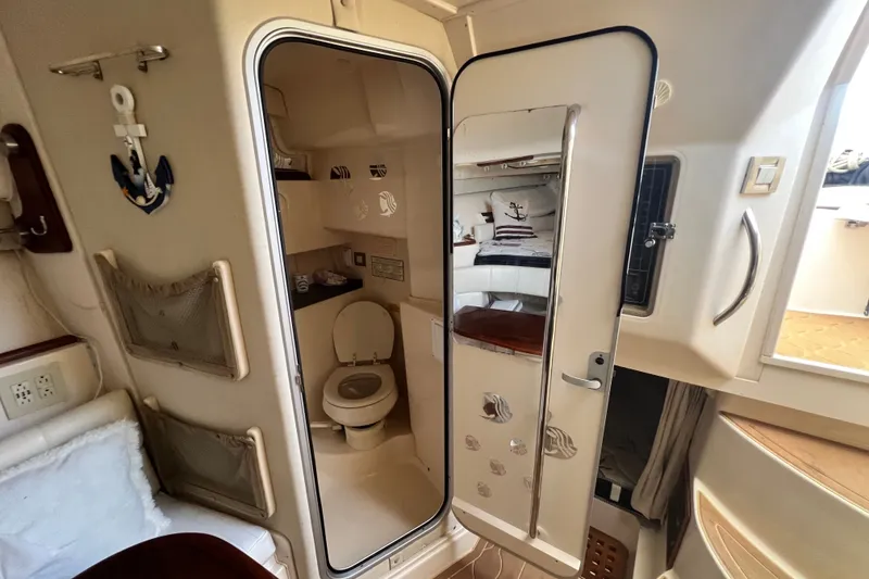 Slide: The Image of Interior of 2006 Grady-White Express 330 boat featuring a compact bathroom. - 31