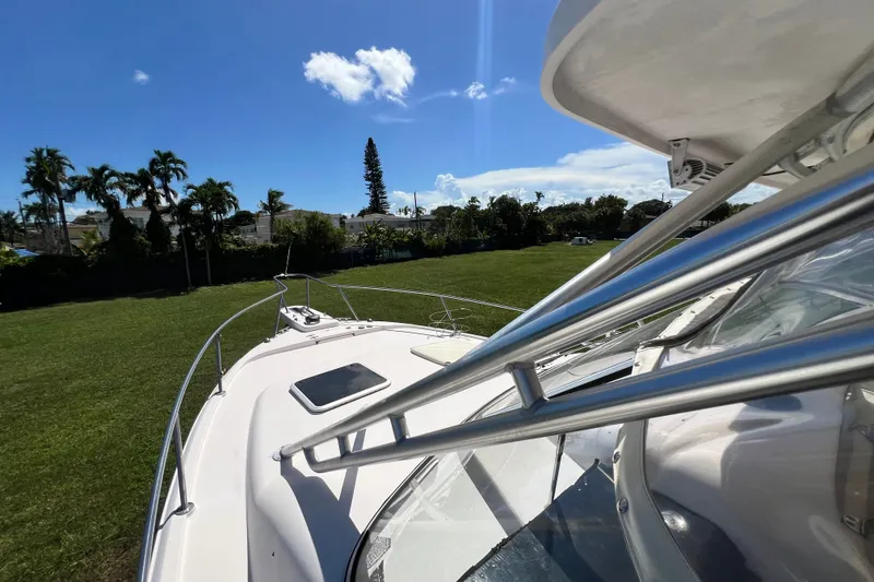 Slide: The Image of 2006 Grady-White Express 330 boat on grassy field under clear blue sky. - 40