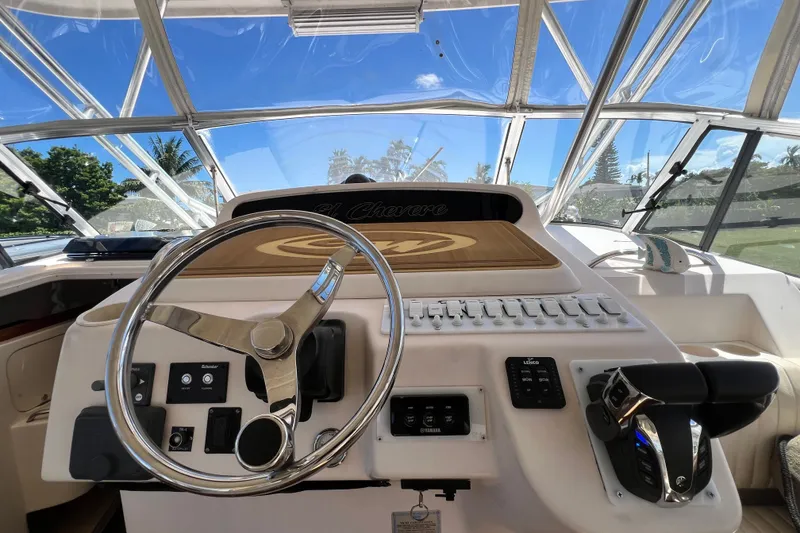 Slide: The Image of Helm of 2006 Grady-White Express 330 boat with steering wheel and controls. - 23