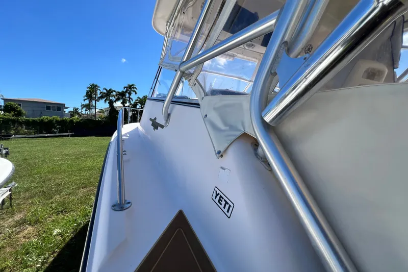 Slide: The Image of 2006 Grady-White Express 330 boat with Yeti sticker, sunny day, grassy background. - 39