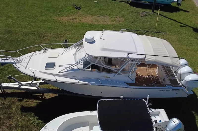 Slide: The Image of 2006 Grady-White Express 330 boat on trailer, parked on grass. - 7