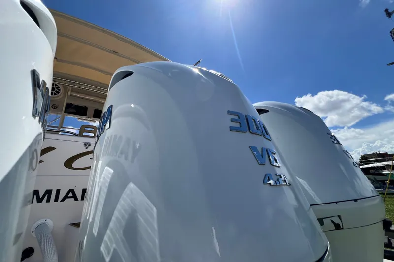 Slide: The Image of Outboard engines on a 2006 Grady-White Express 330 under a clear blue sky. - 62