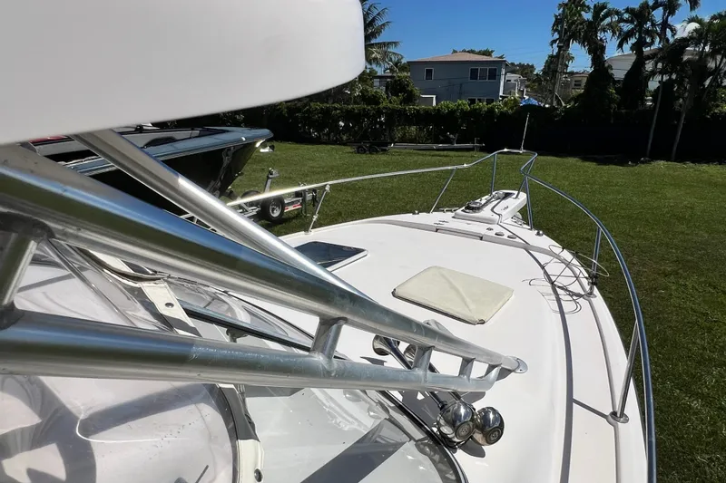 Slide: The Image of 2006 Grady-White Express 330 boat on grass, showcasing bow and railing. - 46