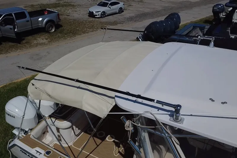 Slide: The Image of 2006 Grady-White Express 330 boat with Yamaha engines, parked near vehicles. - 13