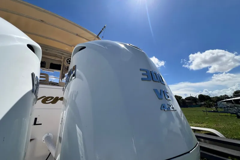 Slide: The Image of 2006 Grady-White Express 330 boat with twin 300 V8 engines under a clear blue sky. - 60