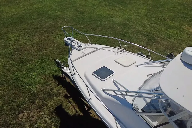 Slide: The Image of 2006 Grady-White Express 330 boat on grass, top view of deck and railing. - 10