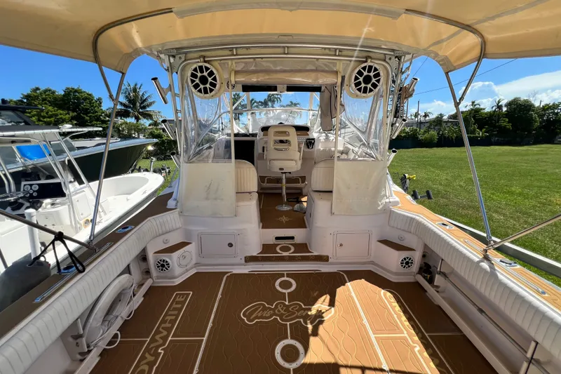 Slide: The Image of 2006 Grady-White Express 330 boat interior with seating and helm, under sunny skies. - 55