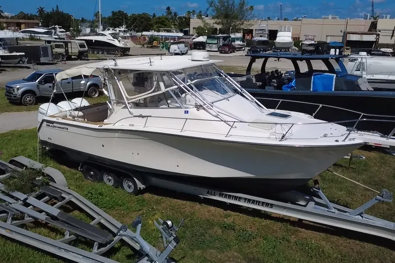 The Image of 2006 Grady-White Express 330 boat on trailer in a marina setting. - 0