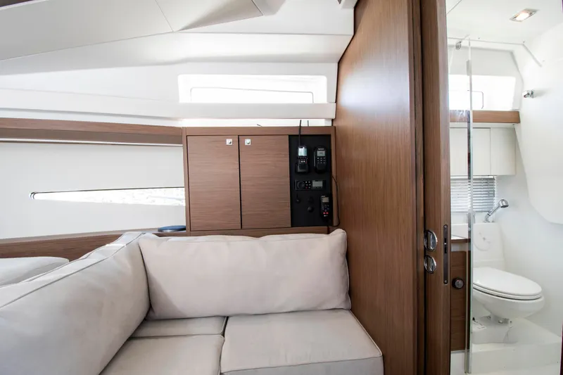 Slide: The Image of Interior of a 2018 Jeanneau Leader 33 featuring a sofa and bathroom. - 2