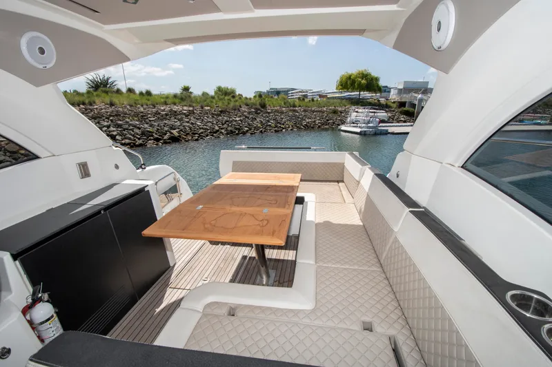 Slide: The Image of The image shows the cockpit of a 2018 Jeanneau Leader 33 with a sleek wooden table. - 11
