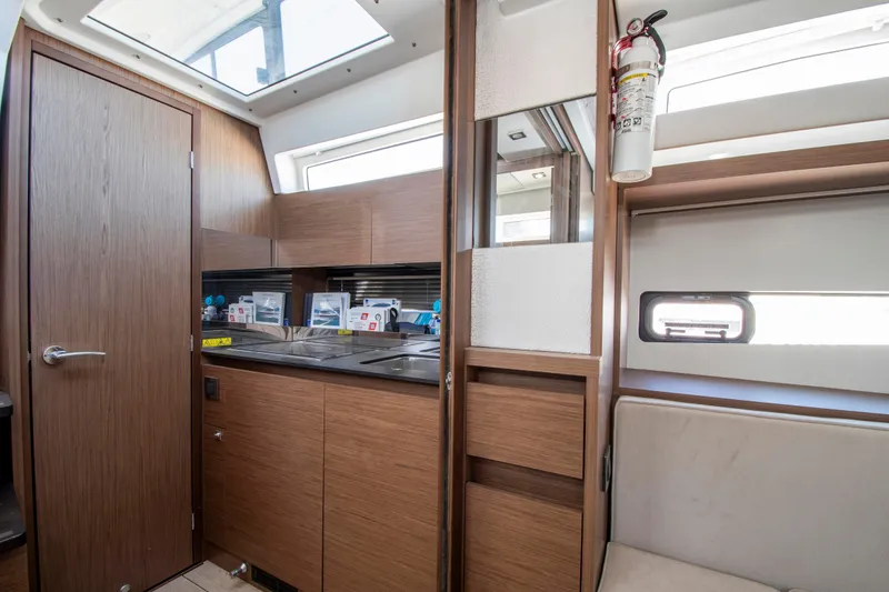 Slide: The Image of Interior of a 2018 Jeanneau Leader 33 with modern kitchen and seating area. - 5