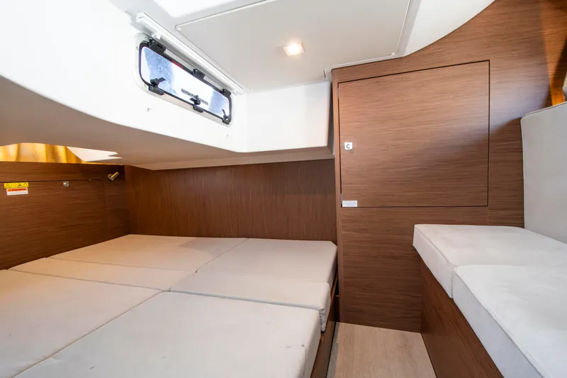 Slide: The Image of Interior of a 2018 Jeanneau Leader 33 with wood paneling and cushioned seating. - 6