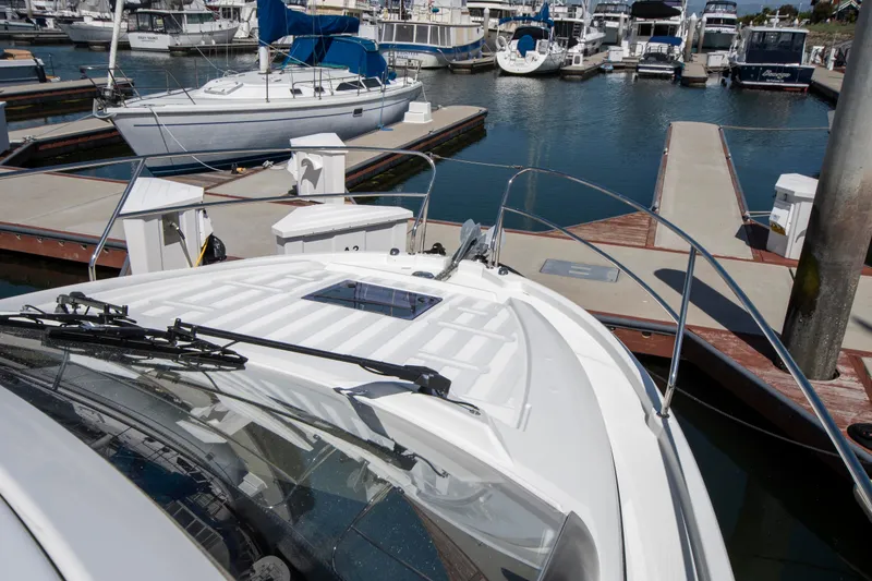 Slide: The Image of A 2018 Jeanneau Leader 33 is docked in a busy marina. - 12