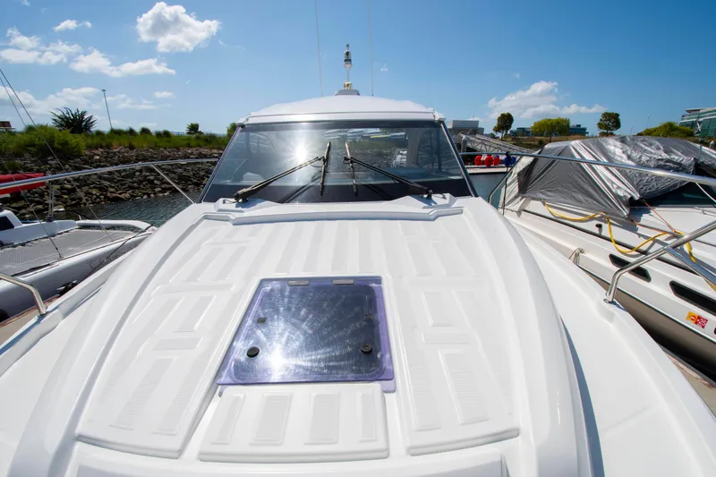Slide: The Image of The 2018 Jeanneau Leader 33 is docked. It features a sleek design and a large deck window. - 14
