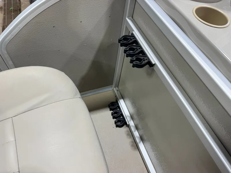 Slide: The Image of Close-up of a boat interior with beige seating and cup holders. - 35