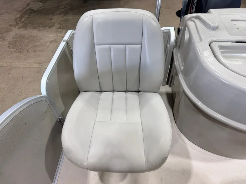 Slide: The Image of A white boat seat with padded design next to a console. - 43