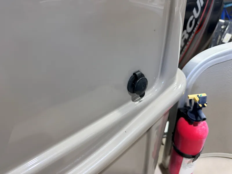 Slide: The Image of Close-up of a boat detail with a fire extinguisher and Mercury engine in the background. - 37