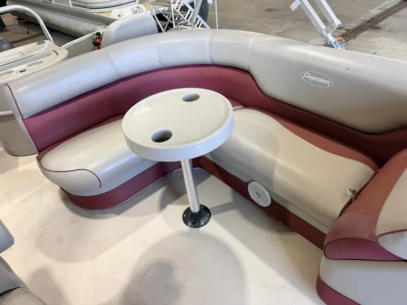 Slide: The Image of A cozy seating area with a round table on a boat. - 26