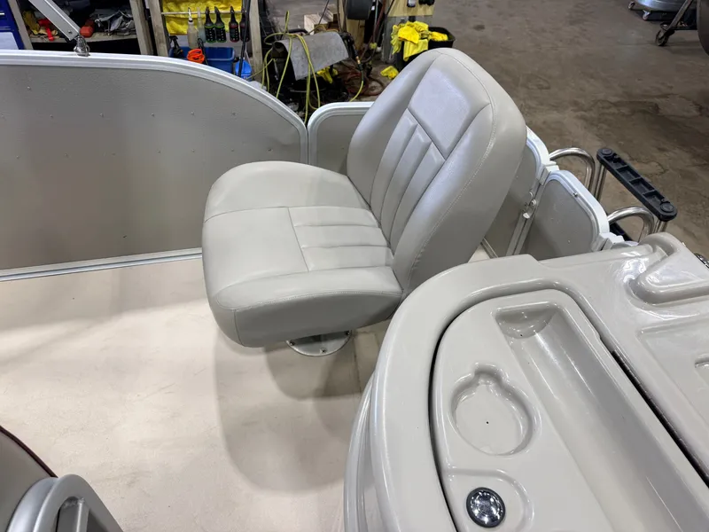 Slide: The Image of A gray seat on a boat with a console and cup holders. - 42