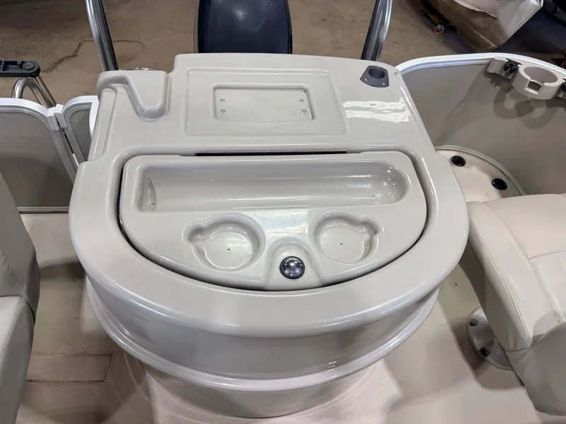 Slide: The Image of The image shows a beige boat console with cup holders and a small compartment. - 40