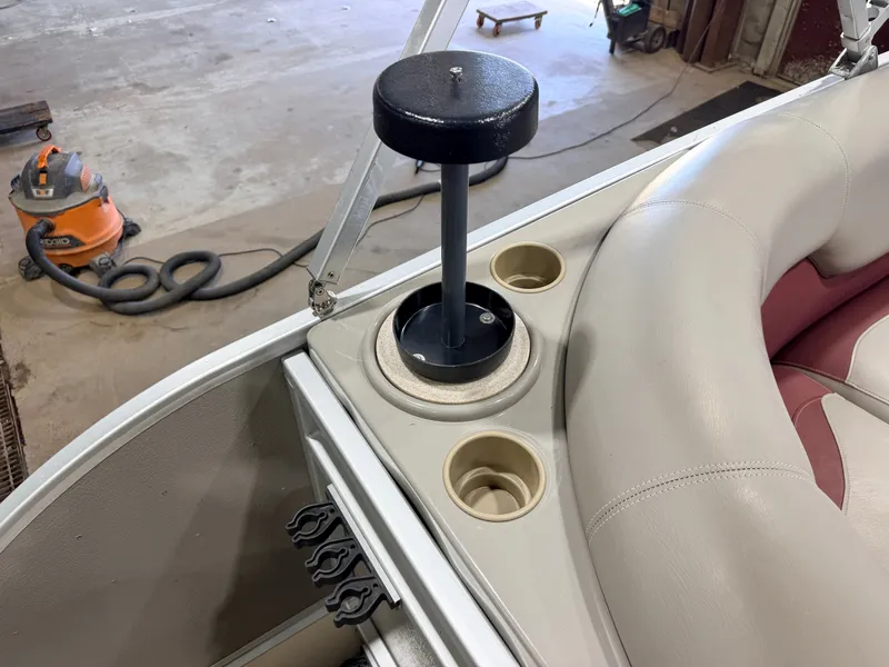 Slide: The Image of Close-up of a boat interior featuring a cup holder and a black stand. - 29