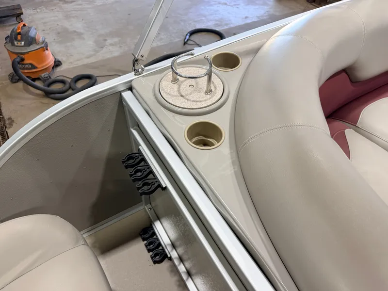 Slide: The Image of The image shows a boat interior with beige and red seating and cup holders. - 28