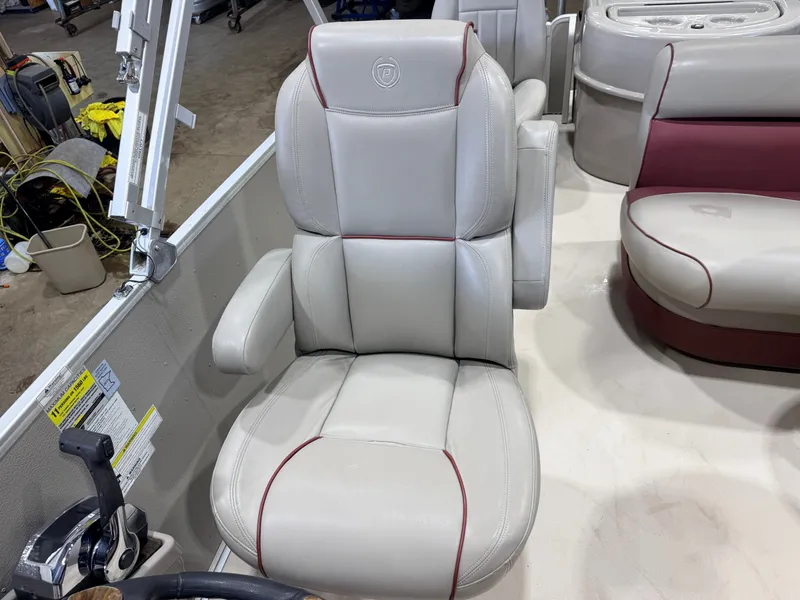 Slide: The Image of A comfortable captain's chair with armrests and red stitching in a boat. - 15