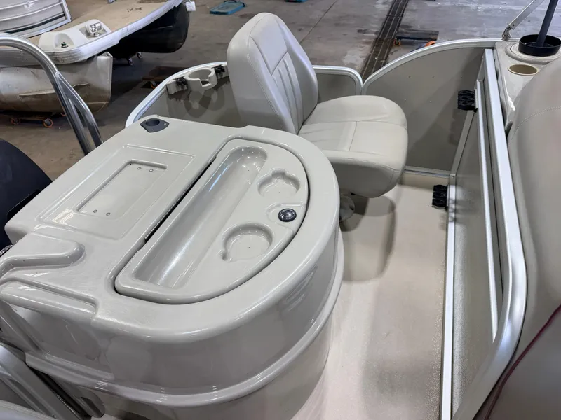 Slide: The Image of The image shows the interior of a Premier 221 Gemini Fish n Cruise boat with a seat and console. - 34