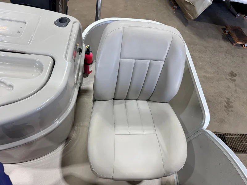 Slide: The Image of A beige seat on a boat next to a console with a dashboard. - 36