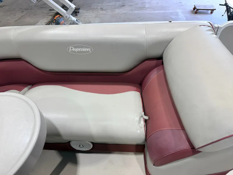 Slide: The Image of The interior of a 2014 Premier 221 Gemini Fish n Cruise with cushioned seating. - 23