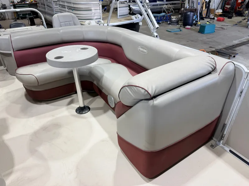 Slide: The Image of The image shows a luxurious seating area on a boat with a small table in the center. - 21