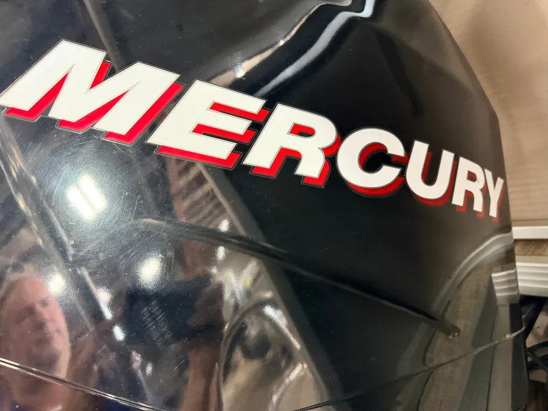 Slide: The Image of Close-up of a Mercury outboard motor with a reflective surface. - 47